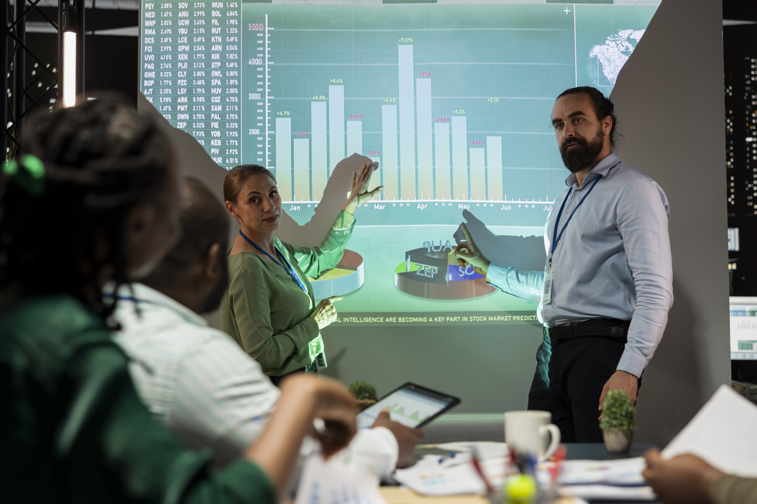 Management team sharing insight on statistics in cost reduction for manufacturing in night corporation meeting