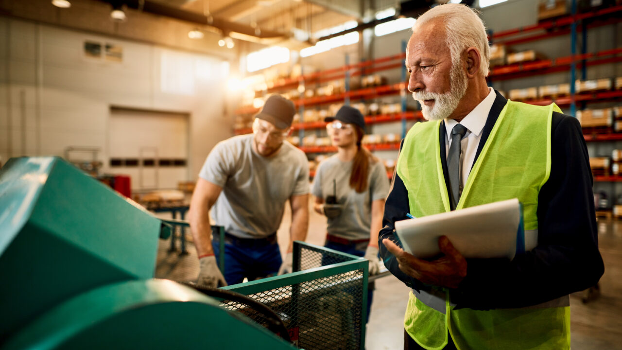 Two workers in a factory warehouse working for Cost Reduction in Manufacturing: A Strategic Approach